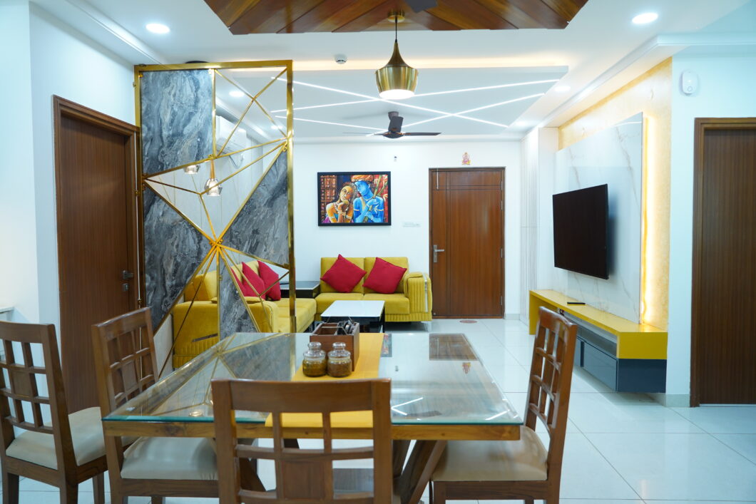 A living room with a dining table and chairs that showcases the creativity of interior designers - Aparna Sarovar Zenith - Nallagandla - Hyderabad - Dream Modular.