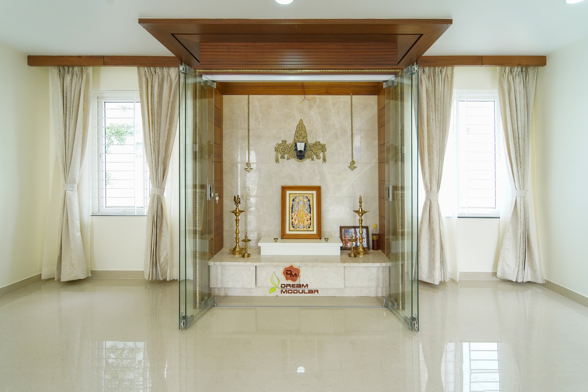 A pooja room with a glass door and white walls, and perfect cabinets for an interior design company in Hyderabad offering a 10-year warranty on all their services.