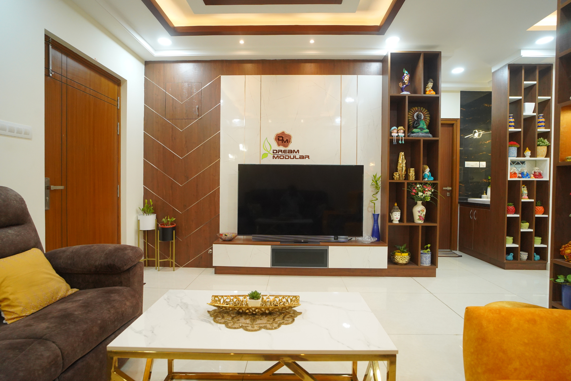 A living room with a tv unit and a coffee table that showcases an impeccable interior design.