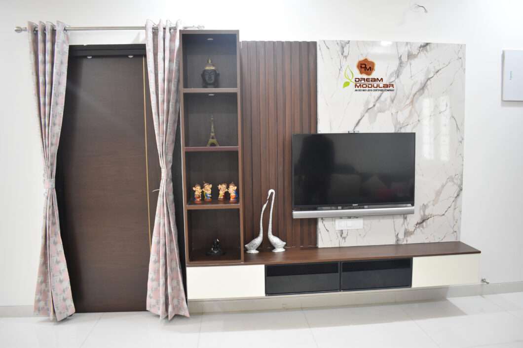 A living room with a marble Acrylic sheet, designed by interior designers for one of their projects and featuring a TV-Honer Aquantis-Tellapur-Hyderabad